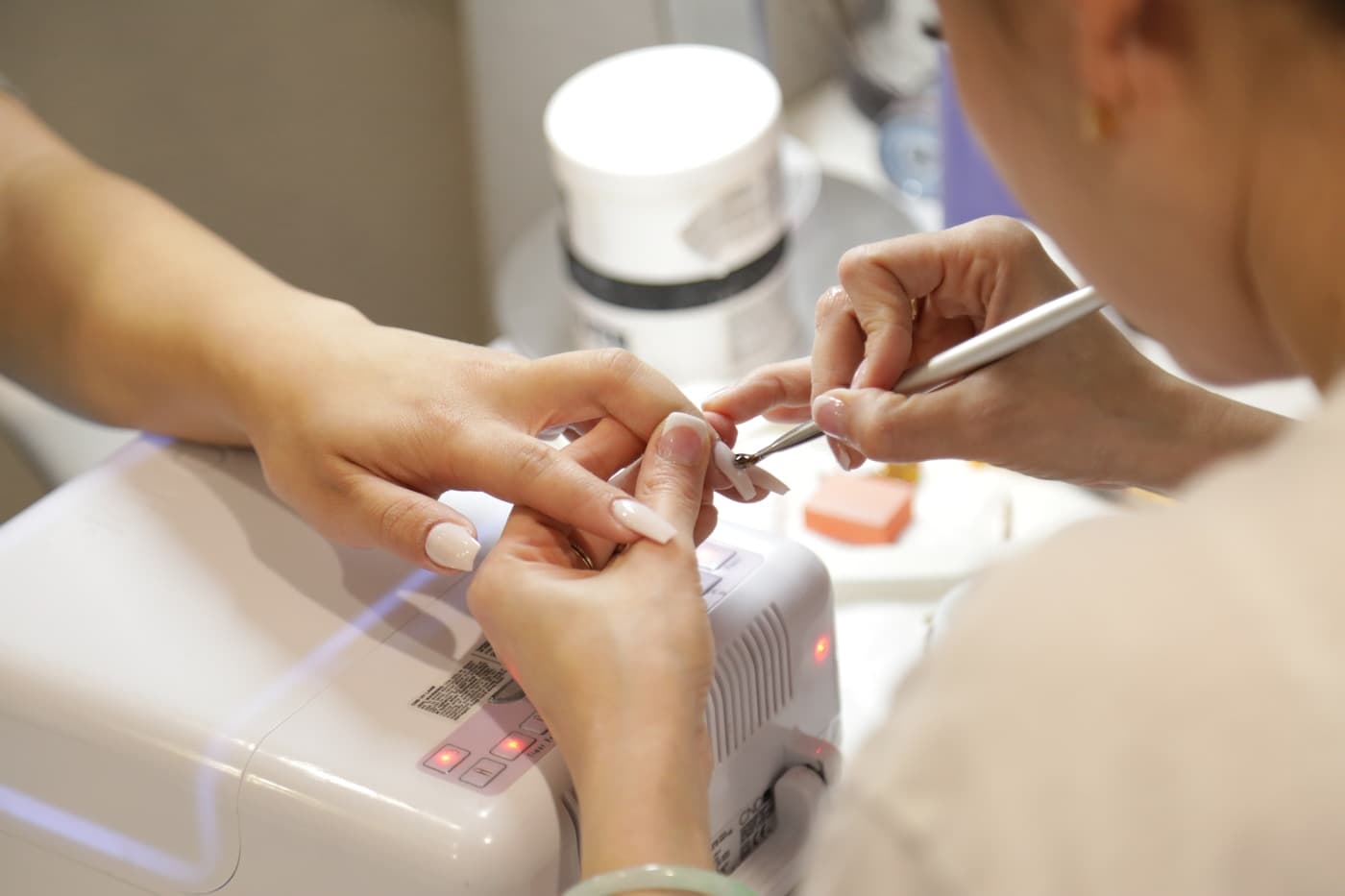 A manicure in progress at a nail salon station